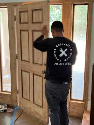 Lazarus Renovation Group Services. A man installing a door.