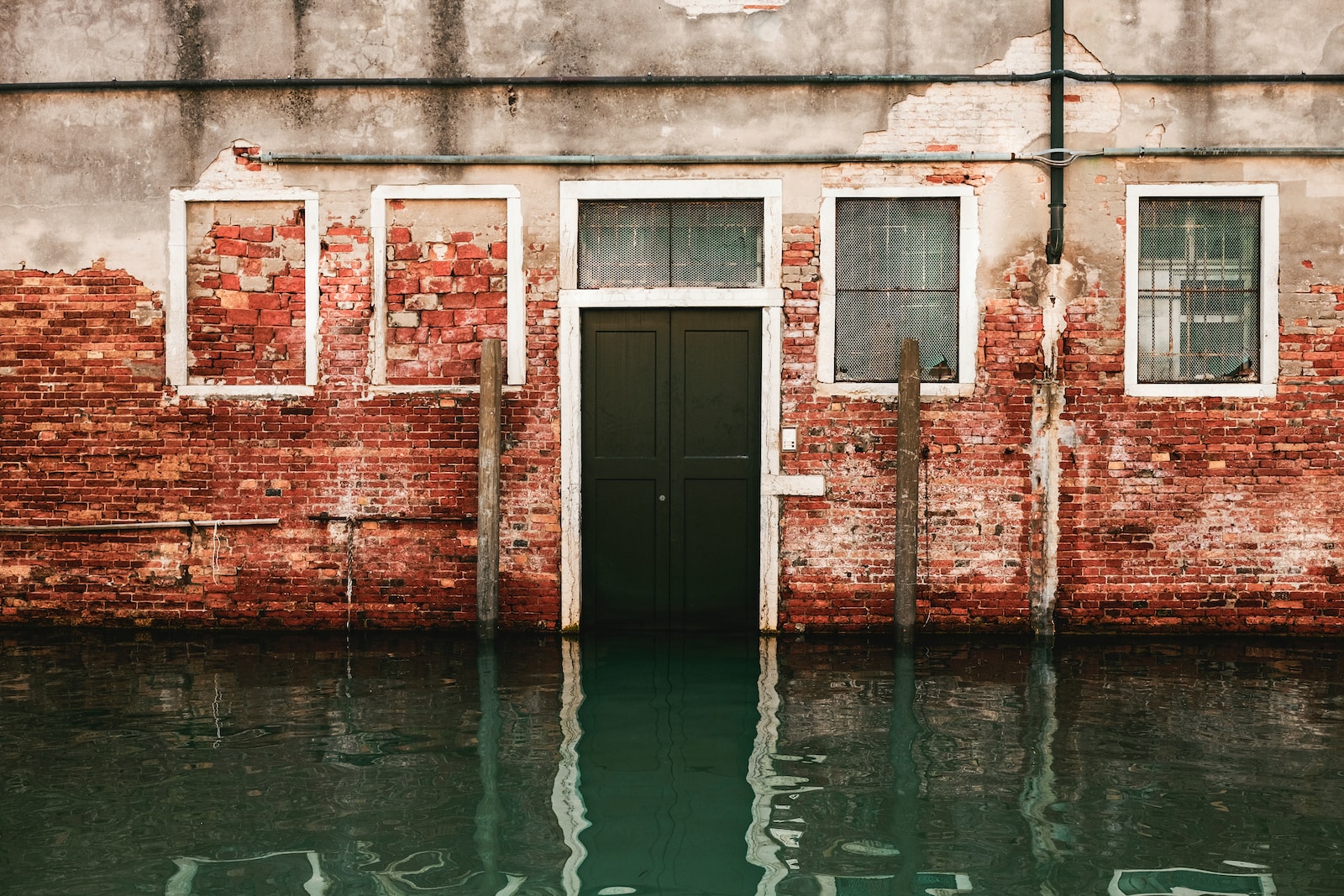 Lazarus Renovation: Water Damage Restoration. A photo of a brick building with water up to the door.