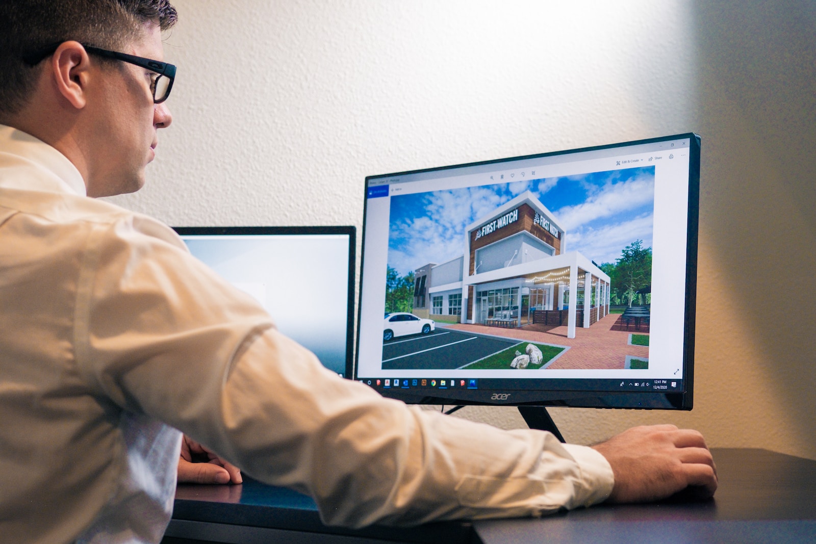 Lazarus Renovation Group: 3 Renderings. A man looking at a computer generated construction rendering.